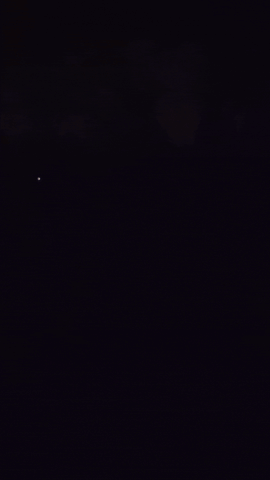 lightning at night with a porch light that remains illuminated after lightning passes