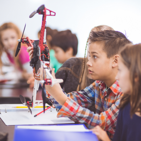 student examining a model helicopter