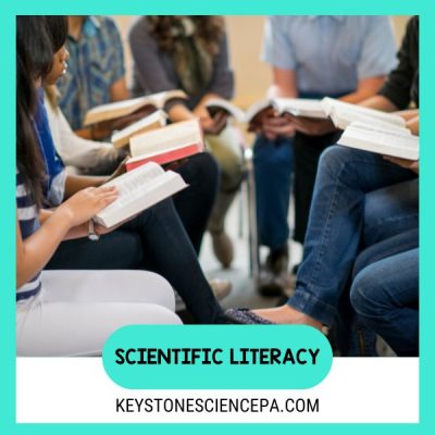 image of students sitting facing one another with books open on their laps. The text Scientific literacy and keystone science website link are below the image